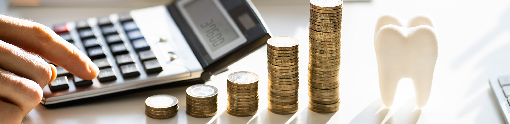 Stacks of coins next to a calculator