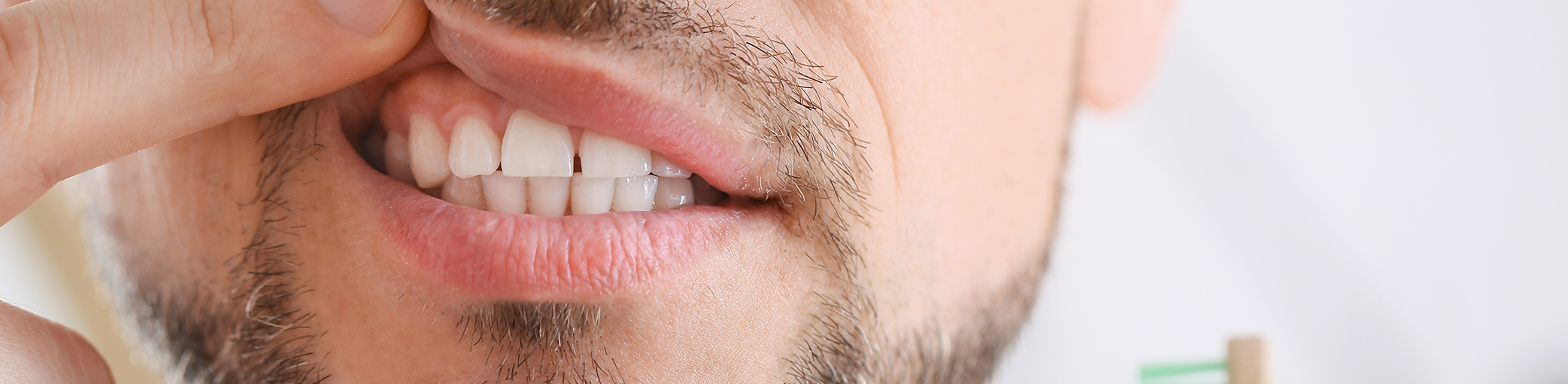 Close up of a man pointing to his gums before gum disease treatment in Bullard