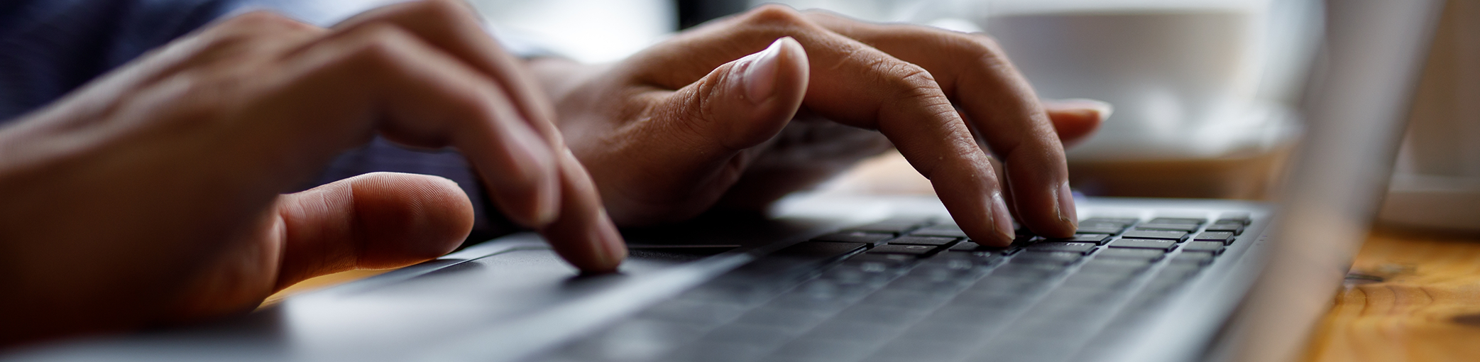 Person typing on their laptop to request a dental appointment in Bullard
