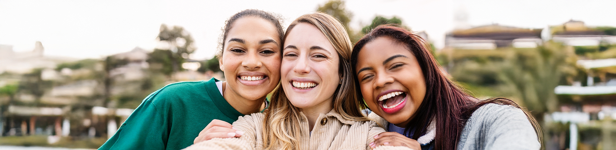 Three young women smiling after restorative dentistry in Bullard