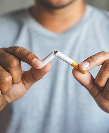 Man breaks cigarette