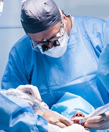 a dentist placing a dental implant