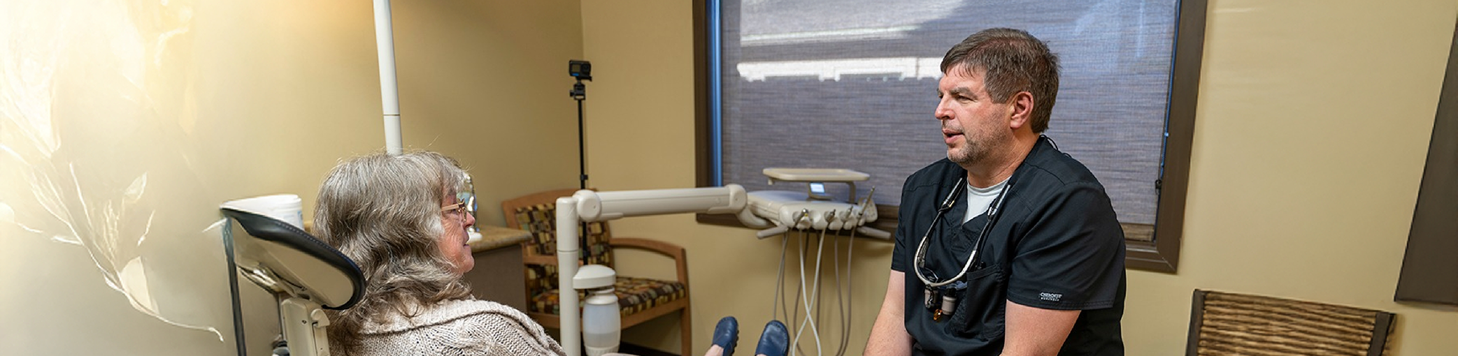 Bullard dentist talking to a patient in the treatment chair