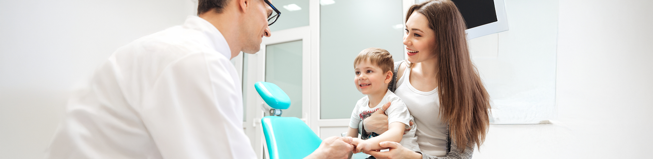 Young boy and his mother at a consultation with a dentist for myofunctional therapy in Bullard