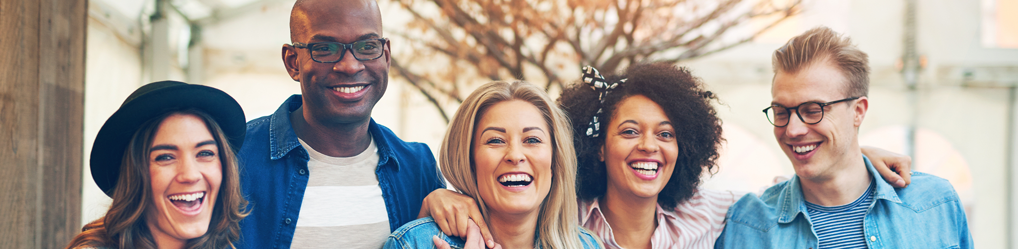 Group of friends smiling and standing in a row