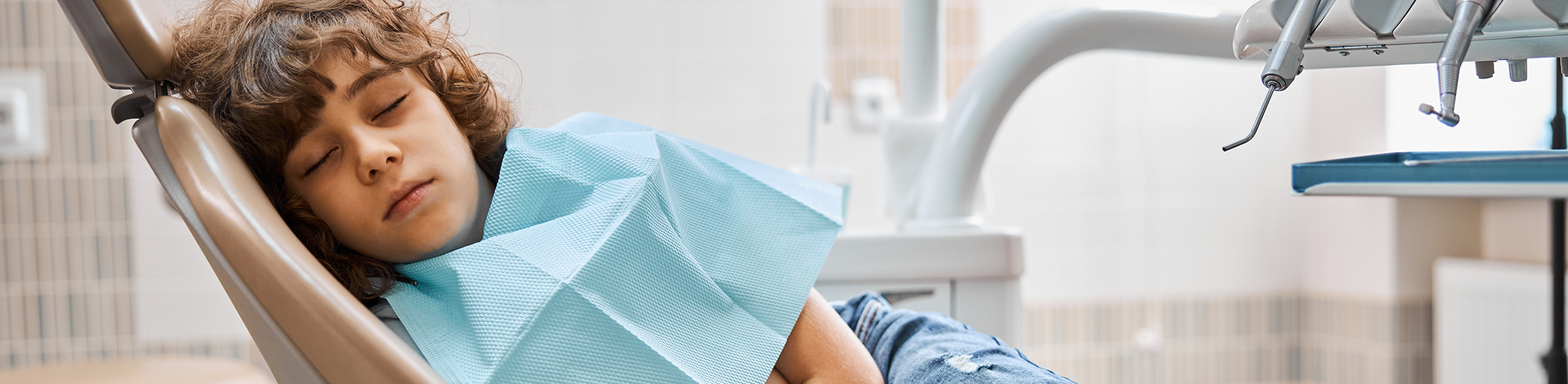 Person relaxing in the dental chair thanks to sedation dentistry in Bullard