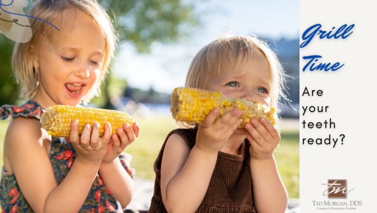 Two young children enjoying corn on the cob outdoors. The text reads, "Grill Time: Are your teeth ready?" with summer bbq season vibes and features the logo of Tad Morgan, DDS, General & Aesthetic Dentistry.